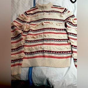 Knit sweater with fringey detail.